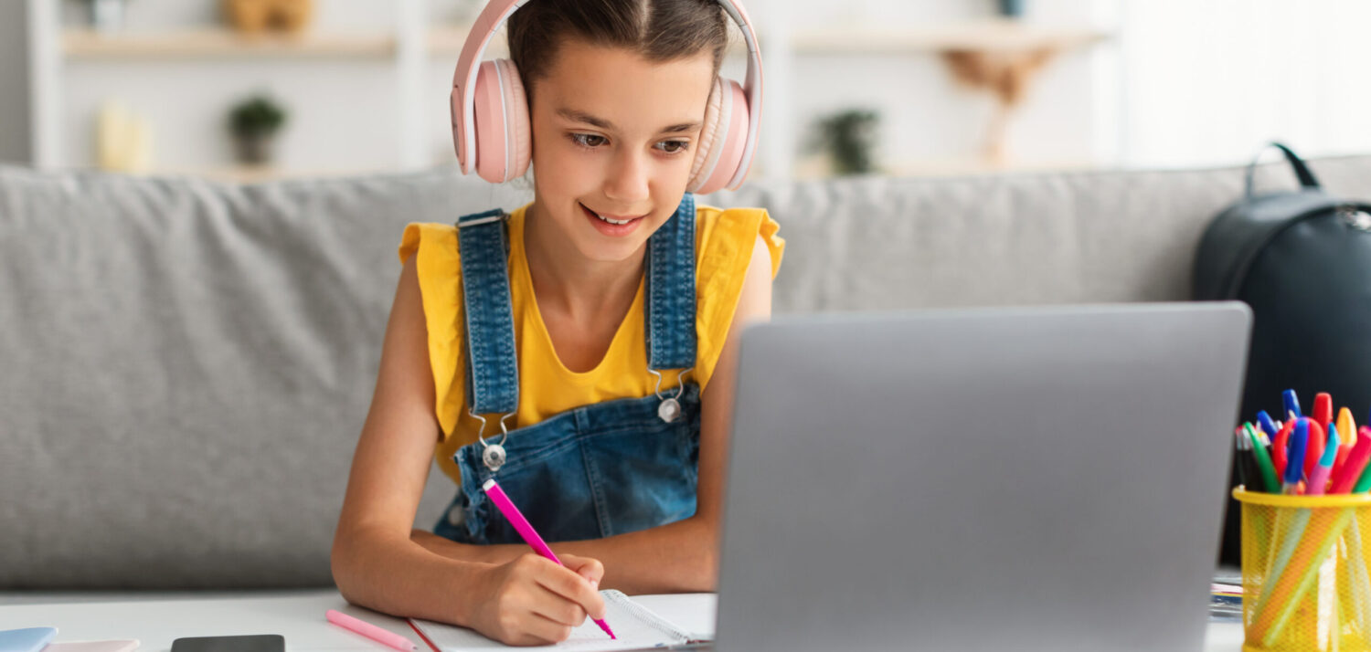 Student learning with headphones at a computer